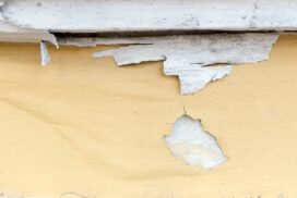 Yellow paint peeling off at concrete wall,texture background